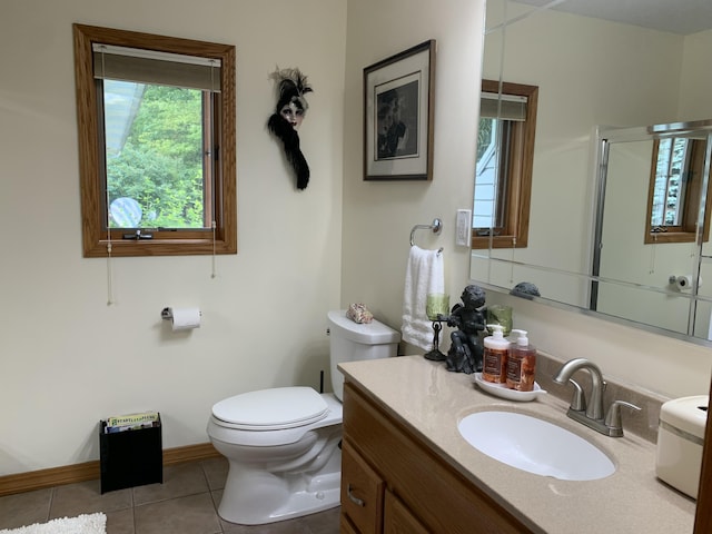 bathroom featuring vanity, tile patterned floors, toilet, and baseboards