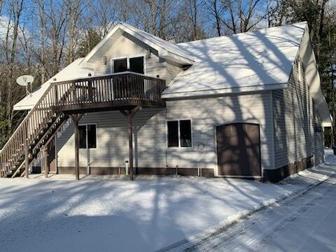 snow covered house with stairway