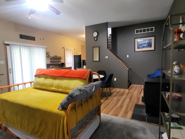 bedroom featuring visible vents and wood finished floors