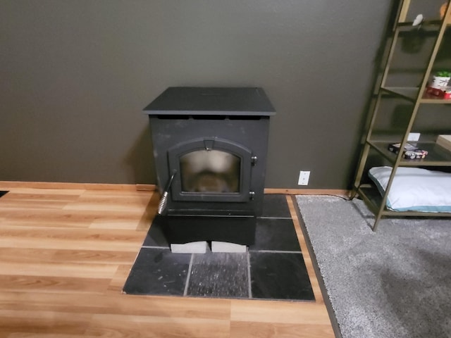 room details with a wood stove and baseboards