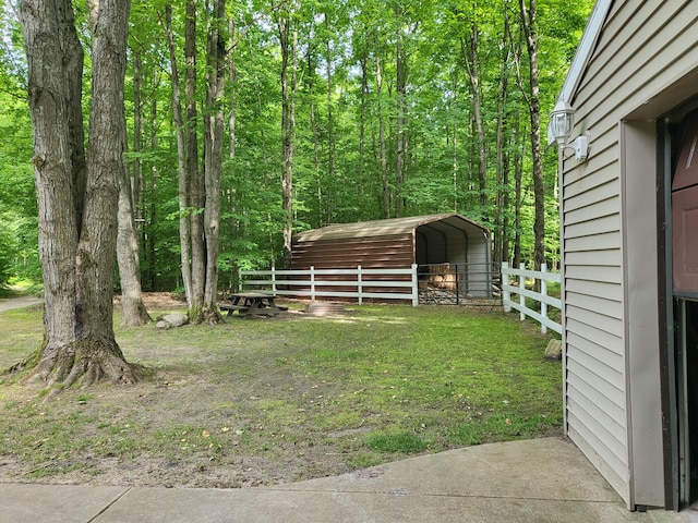 view of yard featuring a detached carport and fence