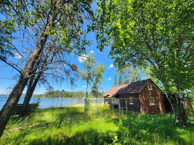 exterior space with fence and a water view