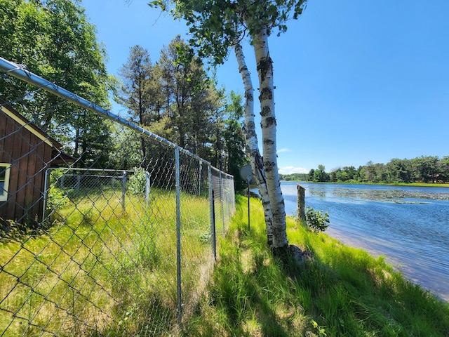 view of yard with fence and a water view