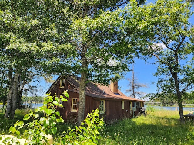 view of property exterior with a water view