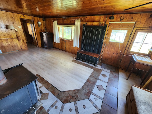 unfurnished living room with wooden ceiling, wooden walls, and wood finished floors