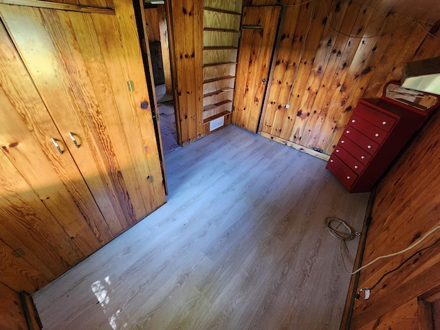 interior space featuring wooden walls and wood finished floors