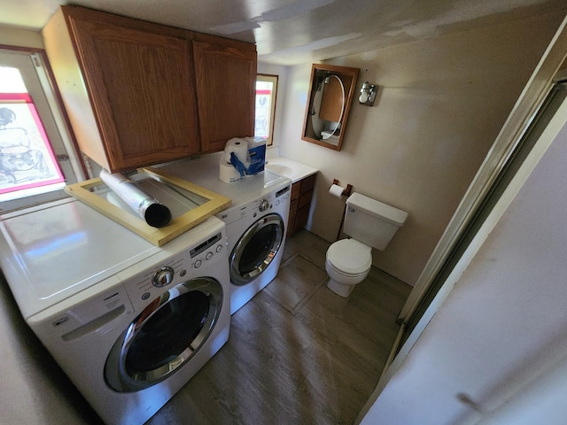 washroom featuring laundry area, wood finished floors, and washing machine and clothes dryer