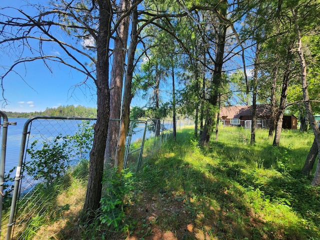 property view of water featuring fence