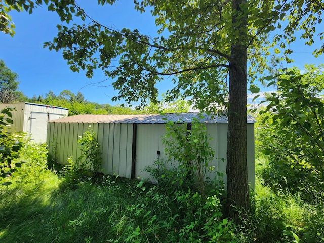 view of property exterior featuring an outbuilding