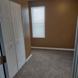 unfurnished bedroom with a closet, carpet floors, and baseboards