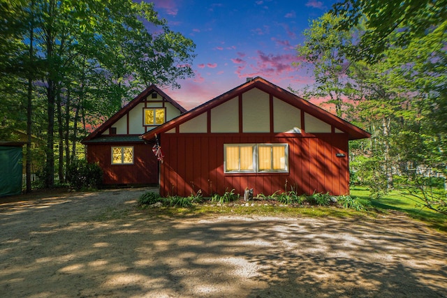 property exterior at dusk featuring driveway