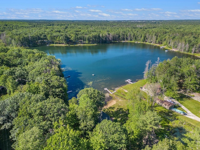 aerial view with a wooded view and a water view