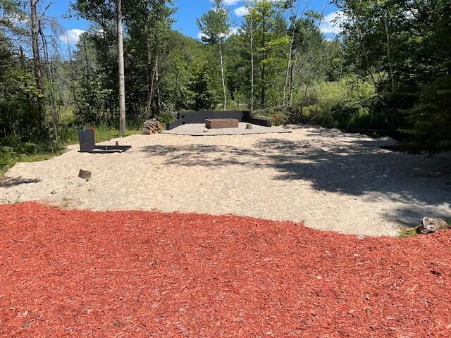 view of yard featuring a forest view