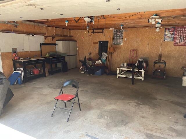 garage with a garage door opener and freestanding refrigerator