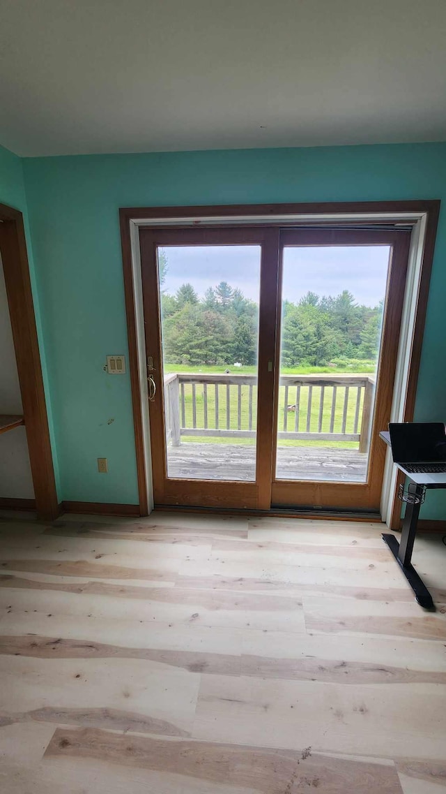 551 S US-23, Harrisville, MI 48740 - doorway featuring baseboards and wood finished floors