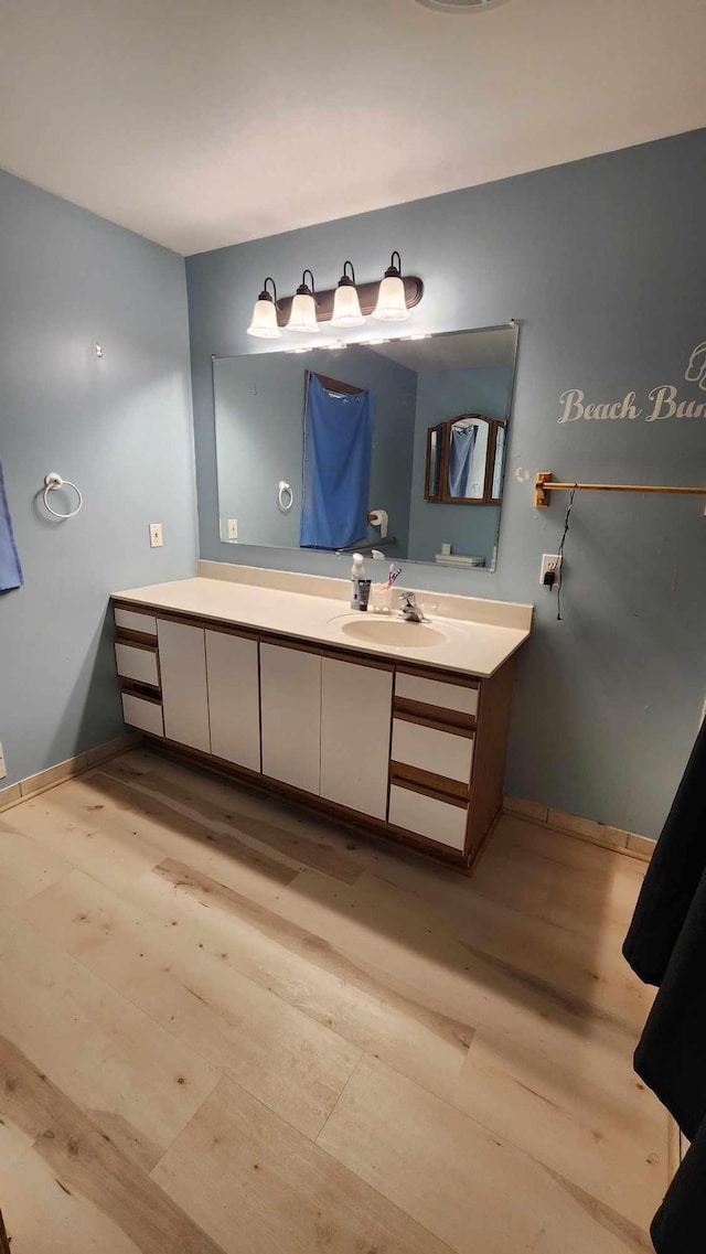 551 S US-23, Harrisville, MI 48740 - bathroom with vanity, baseboards, and wood finished floors