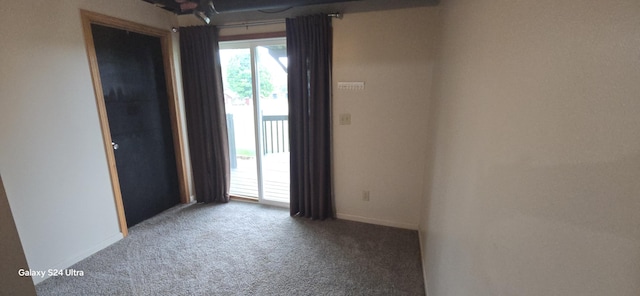 carpeted spare room with baseboards