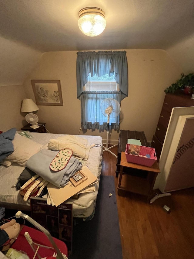 bedroom featuring vaulted ceiling and wood finished floors