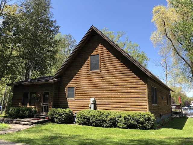 view of side of home featuring a lawn