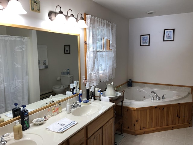 full bath featuring a tub with jets, double vanity, a sink, tile patterned floors, and toilet