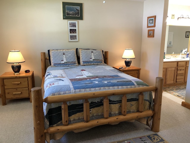 bedroom with light carpet and connected bathroom