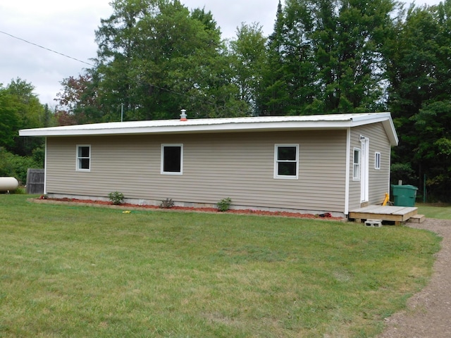 exterior space featuring metal roof and a yard