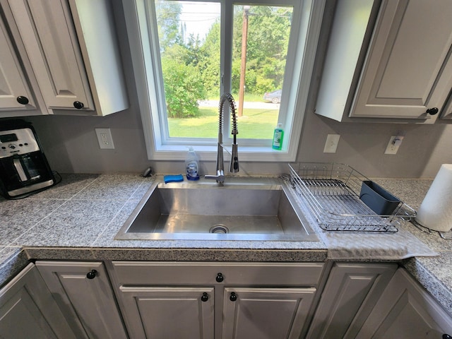 kitchen featuring a sink and tile counters