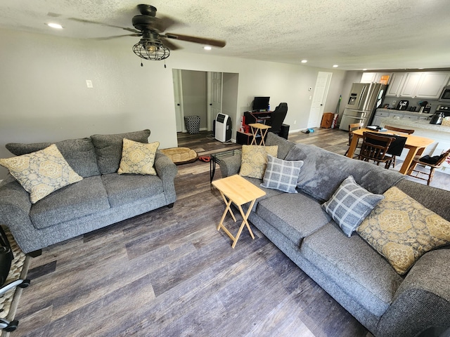 living room featuring heating unit, a textured ceiling, dark wood-style floors, recessed lighting, and ceiling fan