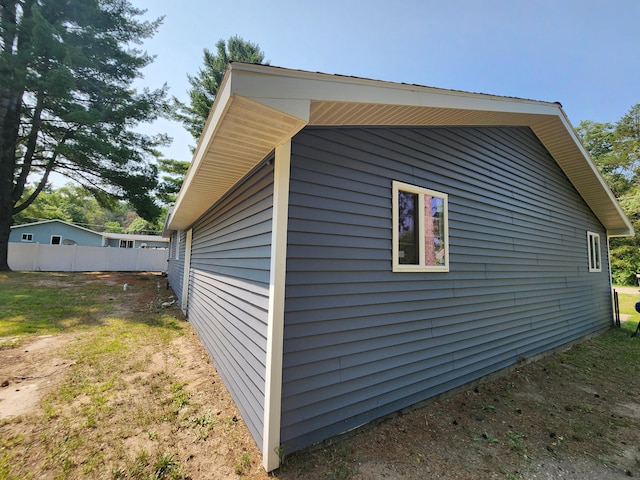 view of home's exterior with fence