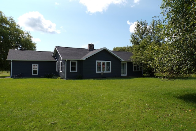 view of front of house with a front yard and a chimney