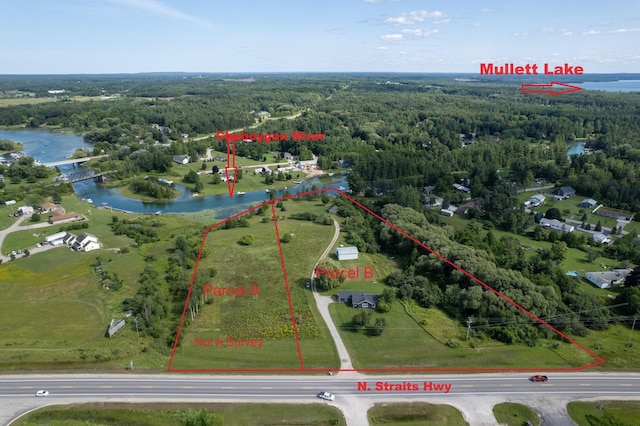 birds eye view of property featuring a view of trees and a water view