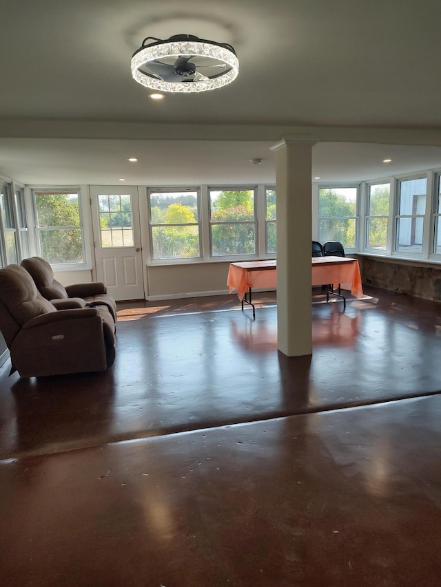 living area featuring plenty of natural light and concrete floors