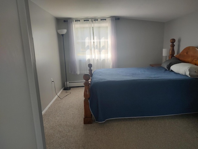 bedroom featuring a baseboard heating unit, baseboards, and carpet floors