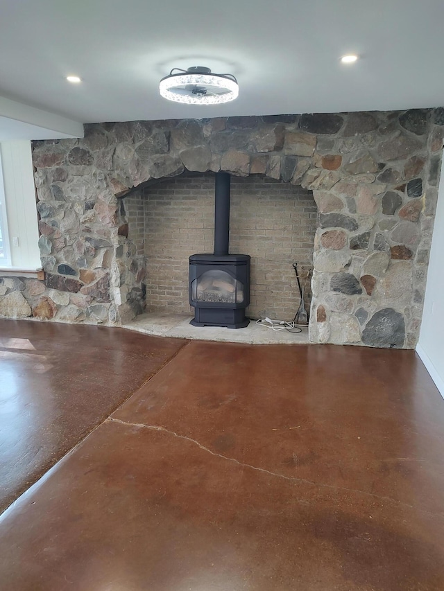 interior details with a wood stove and concrete flooring