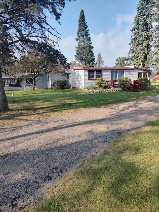 single story home featuring an attached garage and a front lawn