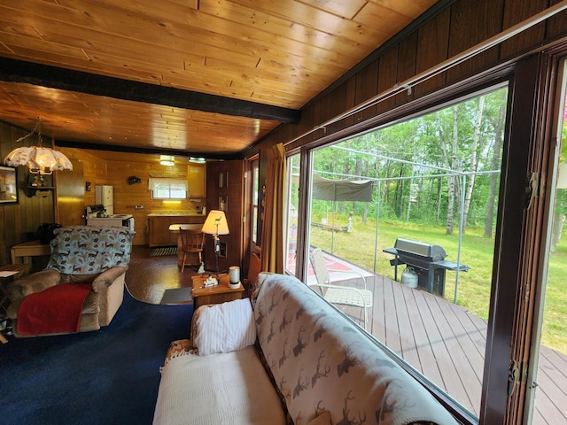 living area featuring wooden walls and wood ceiling