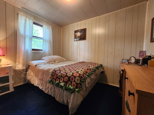 bedroom with baseboards and wooden walls