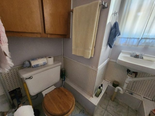 bathroom with toilet and a shower