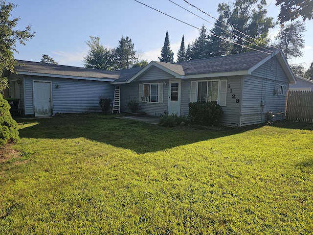 back of house with a yard and fence