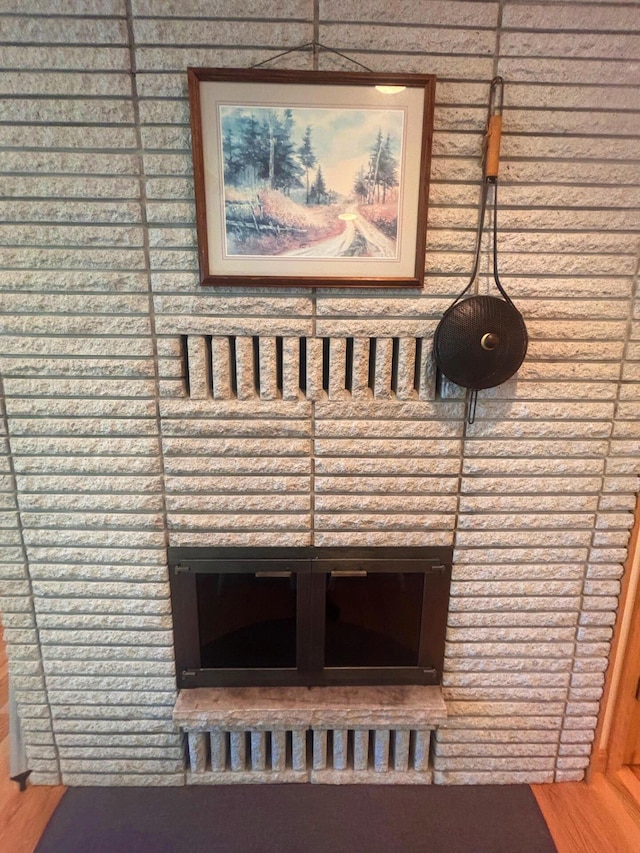 interior details featuring a brick fireplace