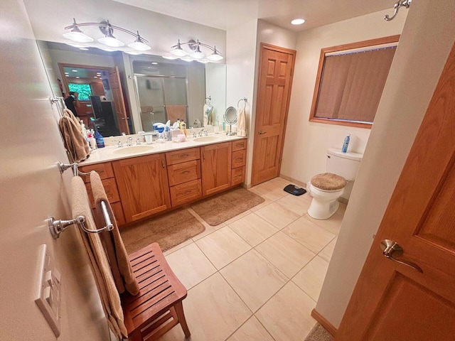 bathroom featuring tile patterned flooring, a shower stall, double vanity, and a sink