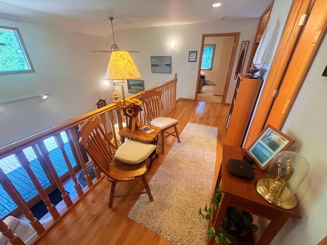 living area with an upstairs landing and light wood-style floors