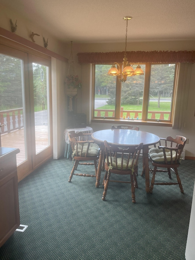 carpeted dining room with plenty of natural light and a notable chandelier