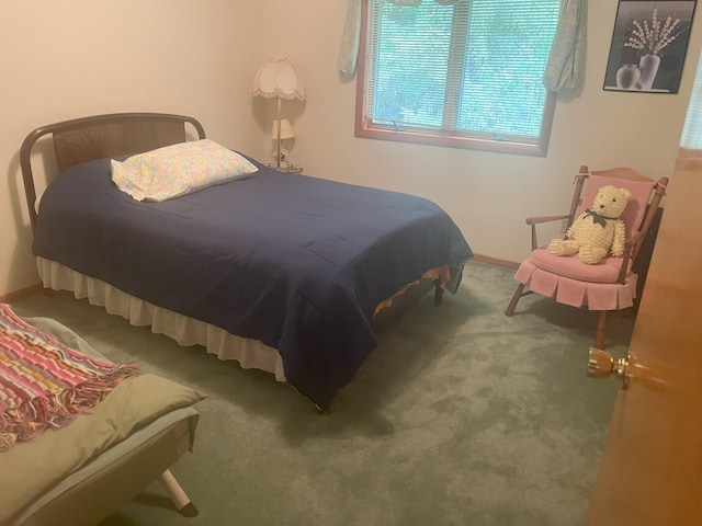 bedroom featuring carpet flooring and baseboards