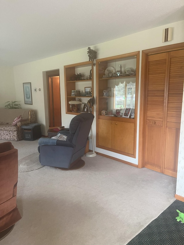 living area featuring carpet floors