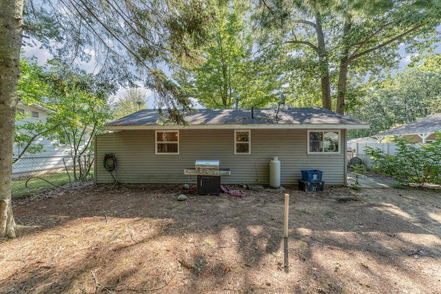 back of house featuring fence