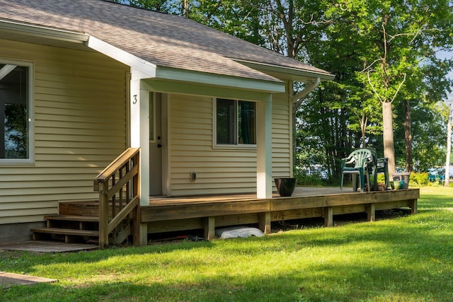 3551 W Otsego Lake Dr, Gaylord, MI 49735 - exterior space with a yard, roof with shingles, and a wooden deck