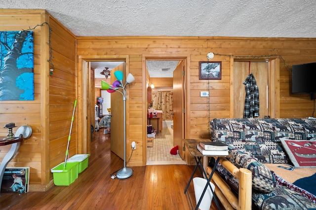 3551 W Otsego Lake Dr, Gaylord, MI 49735 - interior space featuring a textured ceiling, wood finished floors, and wood walls