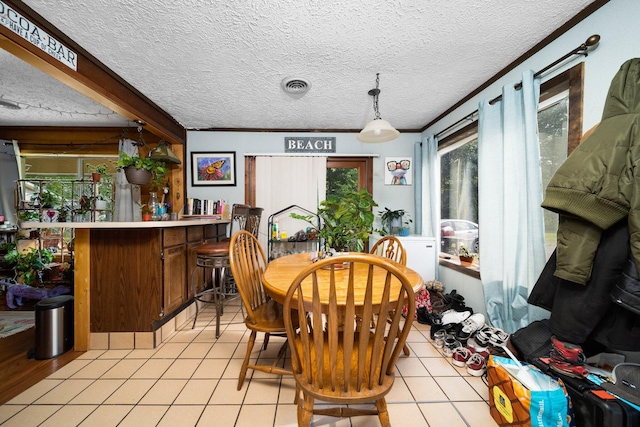 3551 W Otsego Lake Dr, Gaylord, MI 49735 - dining room featuring light tile patterned floors, visible vents, a bar, and a textured ceiling