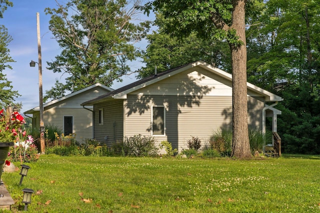 3551 W Otsego Lake Dr, Gaylord, MI 49735 - view of side of home featuring a lawn